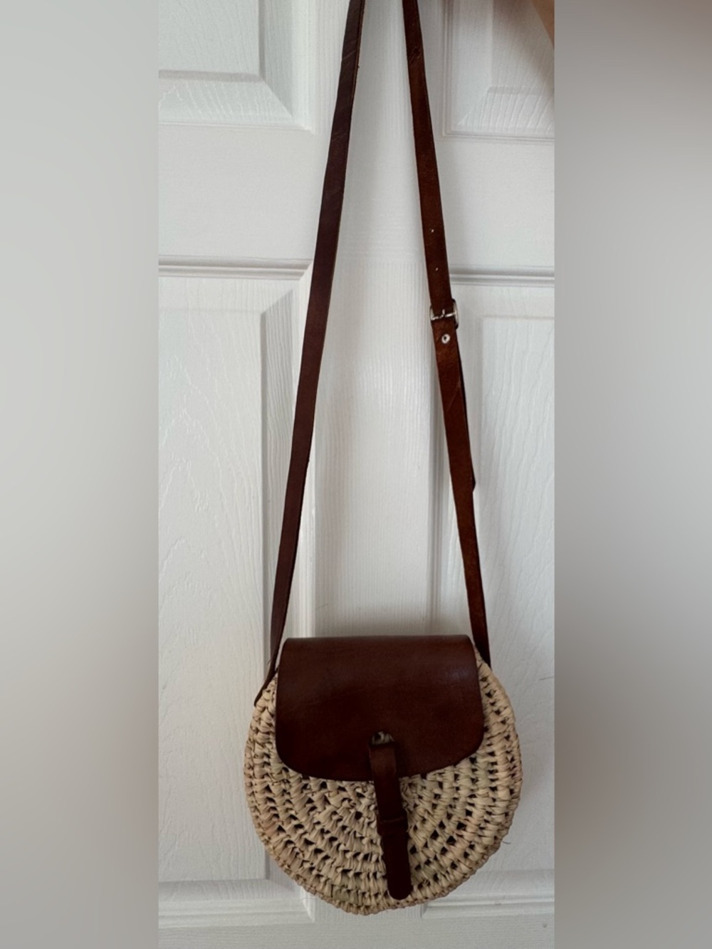 Ratan and leather strap round crossbody purse with flap